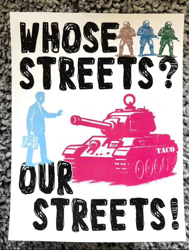 Sign reads: WHOSE STREETS? OUR STREETS!