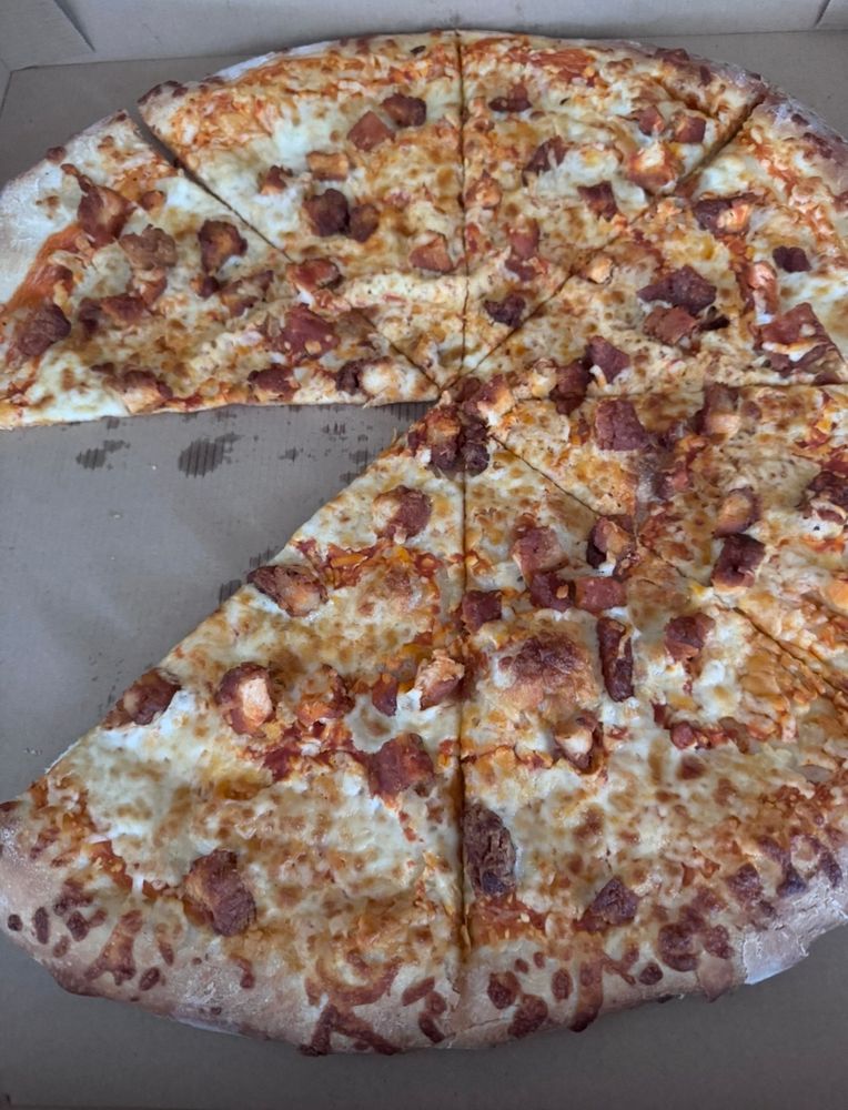 A picture of buffalo chicken pizza with one slice missing
