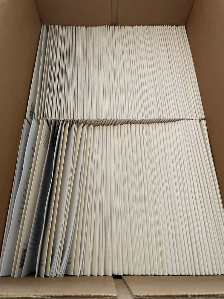 A box of bundled copies of Colossal ready to be sent off for saddle stitching
