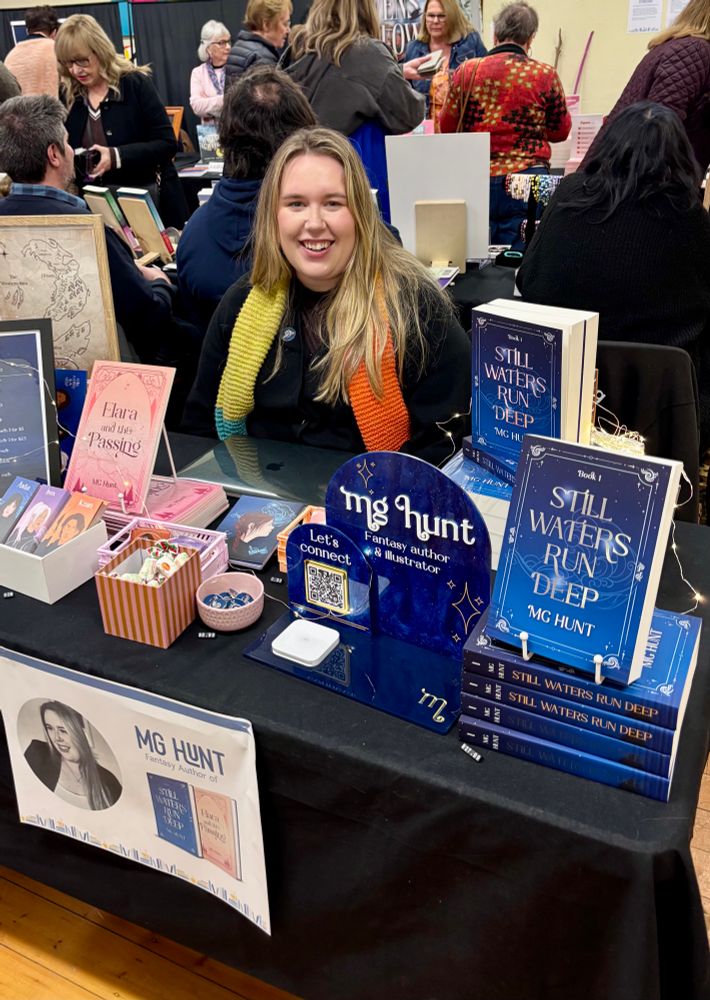 Author MG Hunt seated at her book signing table.