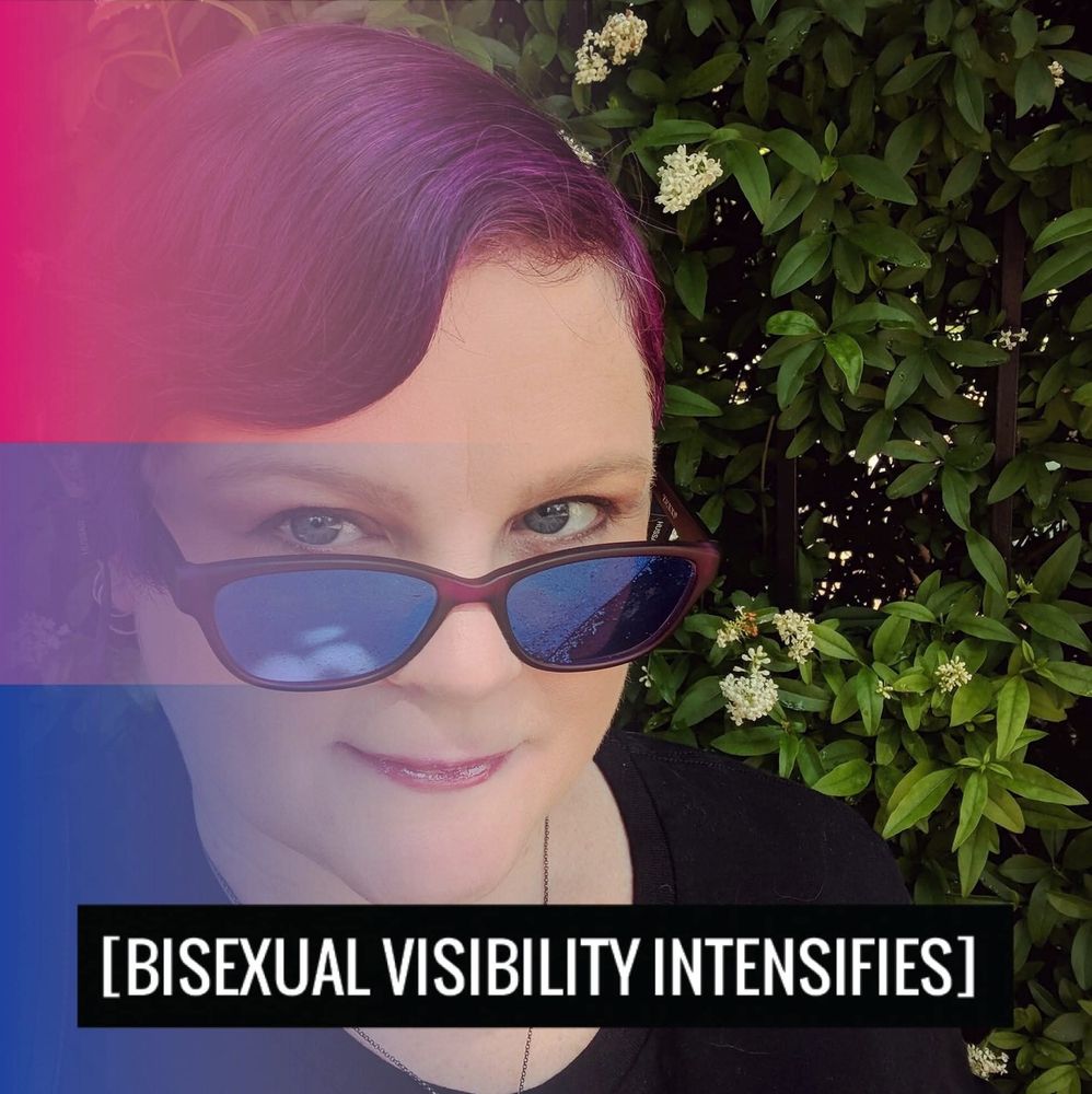 A person with short purple hair is looking over the top of their purple mirrored sunglasses with a sly smile. They look very cool. The bisexual flag of pink, purple and blue fades in from the left side of the image slightly obscuring the left side of their face.
The text at the bottom reads "Bisexual Visibility Intensifies" 