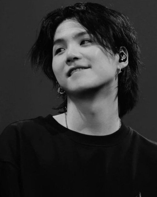 Yoongi in all black, long hair, earpieces in, looking right and biting his lip. It is against federal law to look this hot in public. Think of the riots and mass hysteria caused by his teeth scraping gently on his bottom lip. There, see? Illegal.