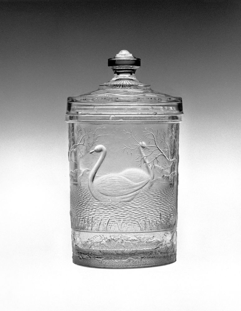 The "Swimming Swan” pattern on a pressed glass jar with glass lid.