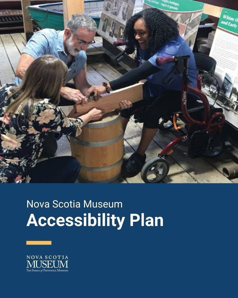 Kiera smiles while sitting on her walker as she planes a piece of wood with the boatbuilder at the Maritime Museum of the Atlantic, with the text Nova Scotia Museum Accessibility Plan.