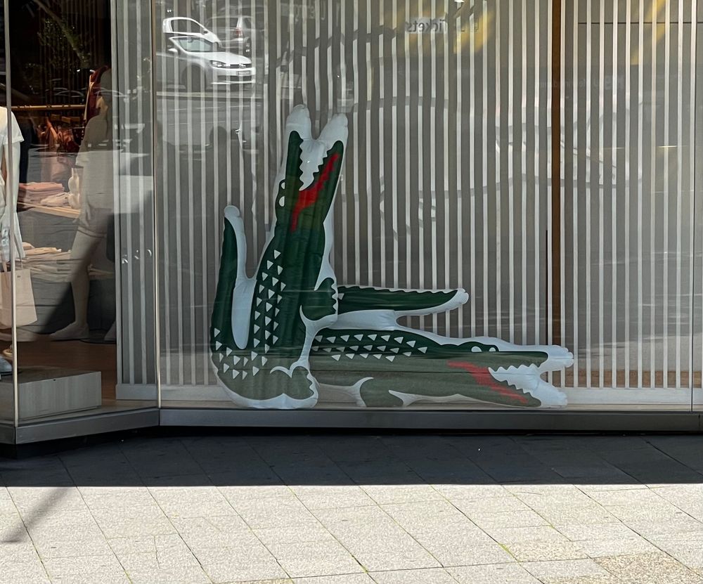 Two alligators fucking in a store window display.