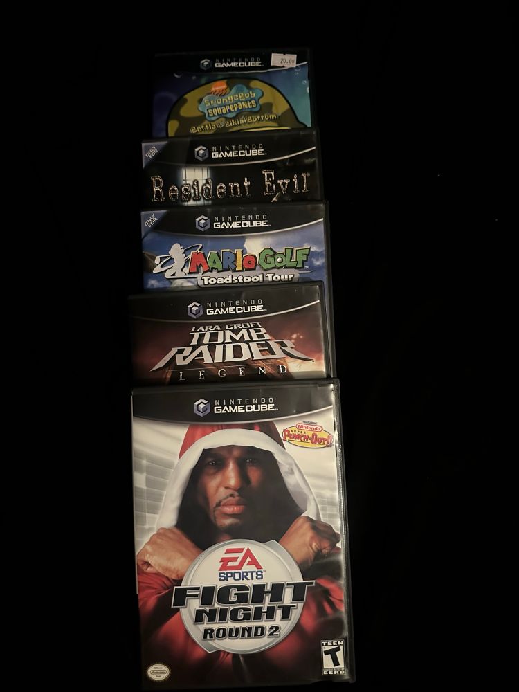 Battle for Bikini Bottom, Resident Evil remake, Toadstool Tour, Tomb Raider Legend and Fight Night Round 2 stacked on top of each other in that order.