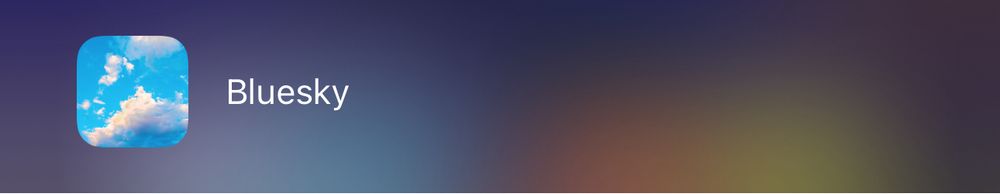 A screenshot of the original Bluesky logo depicting white clouds against a blue sky.