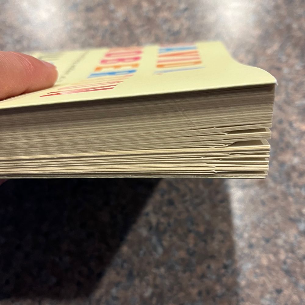 Close up of side of book with several pages at end bent over for future reference.