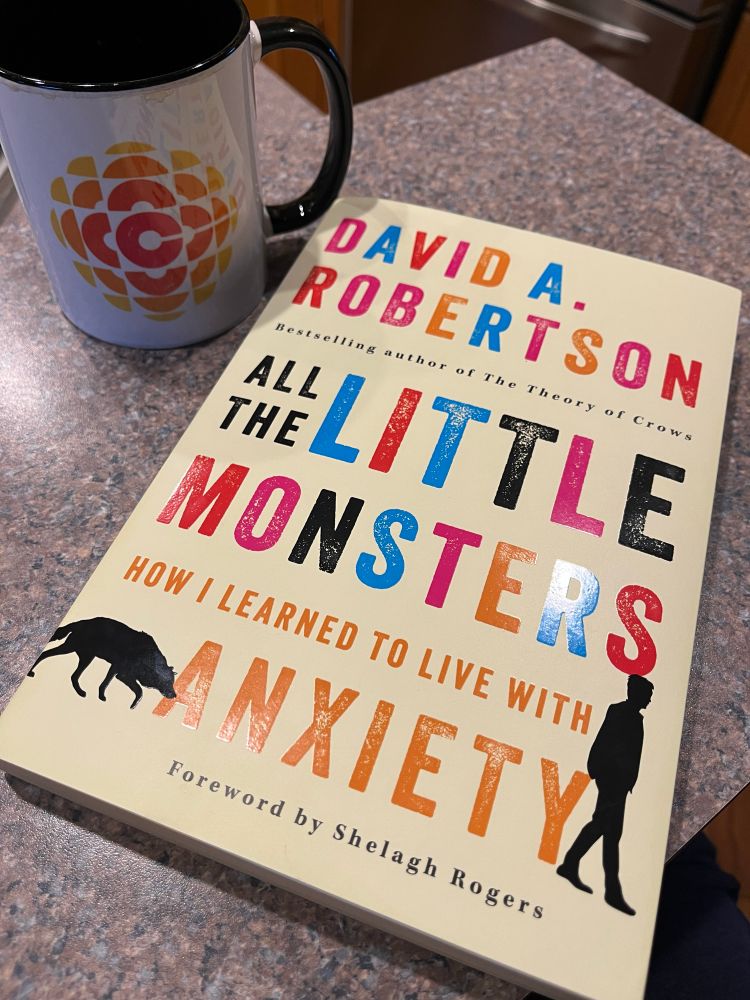 Front cover of David A. Robertson’s “All the Little Monsters: How I learned to live with Anxiety.” Published by Harper Collins, 2025. Mug with CBC logo in background.