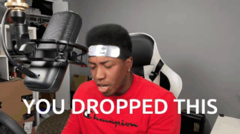 a man sitting in front of a microphone with the words " you dropped this " on the bottom