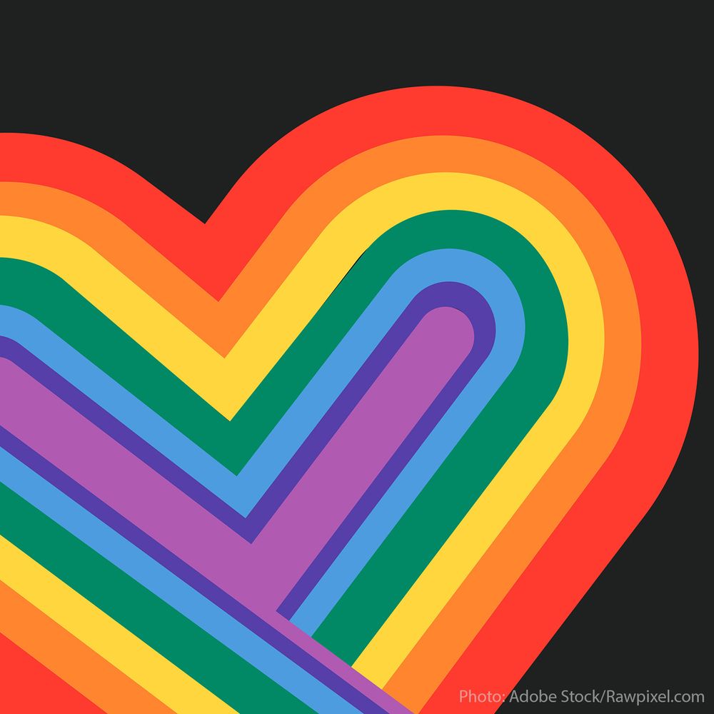 Big heart in rainbow colors with black background.