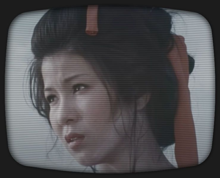 a screenshot of Okiku, the female lead in s01e08 of the Zatoichi TV series, looking to the left, with a red scarf tied in her hair.
