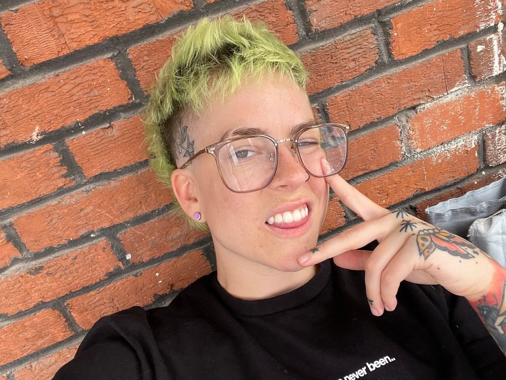 selfie also in front of an old ass brick wall, this time in LANDSCAPE MODE and i’m making a face idk, and also im touching my face because idk what to do with my hands in pictures 
