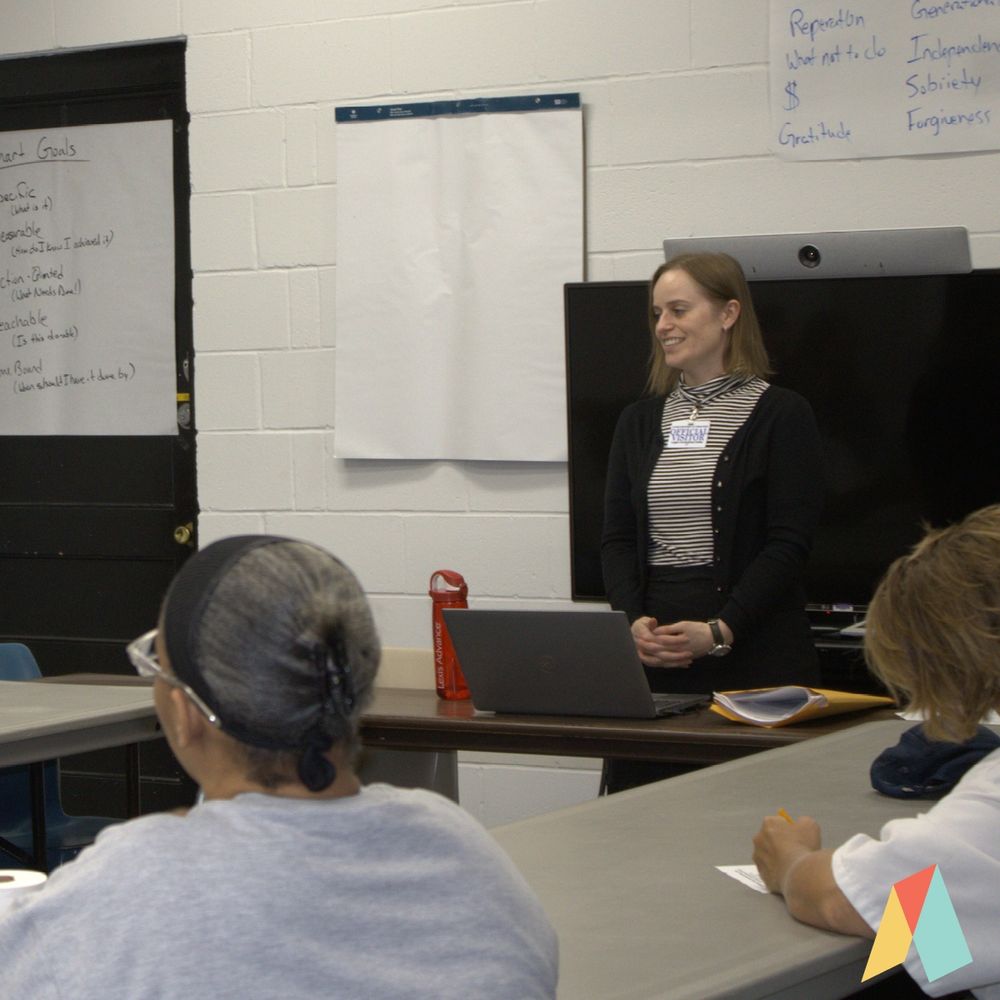 Ascend Justice attorney Mary Kate Winn stands in front of a class of incarcerated women at Logan Correctional Facility