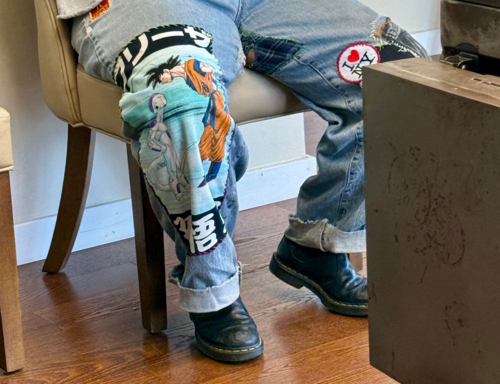 amanda’s jeans that are covered in patches. a huge part of the right leg is dragon ball z shirt featuring goku looking down at frieza 