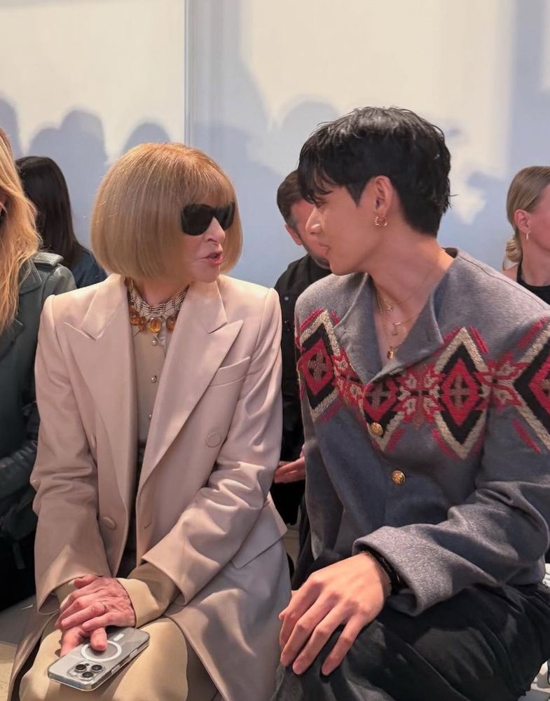 Anna Wintour and Taehyung sitting together and conversing 