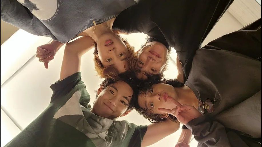 jimin, taehyung, jungkook, and hobi taking a photo in a circle as they look down at the camera after the busan concert 