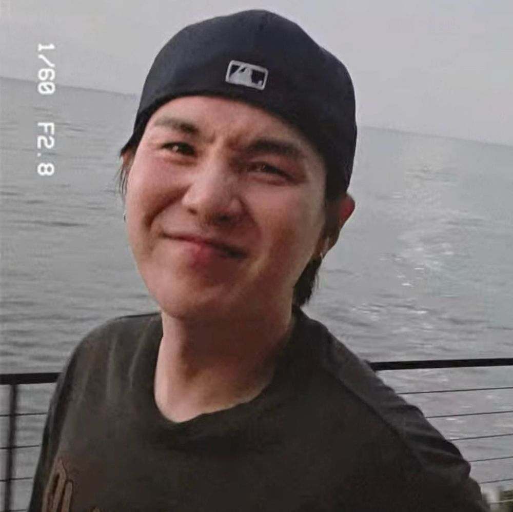 older min yoongi with a backward cap scrunching his nose 