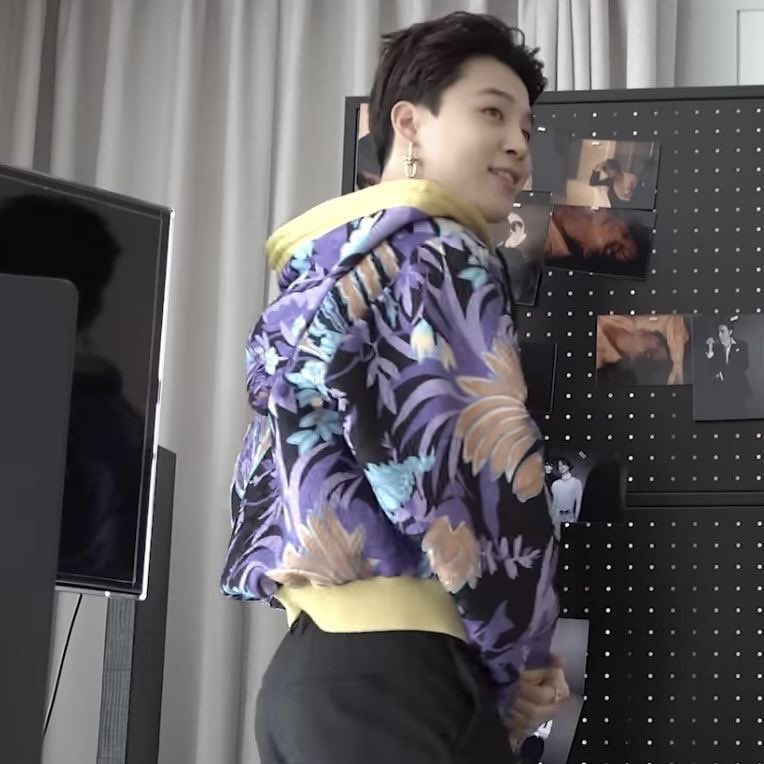 jimin looking over his shoulder with a purple pattern sweater. his short hair is pushed back and his glorious ass on display.