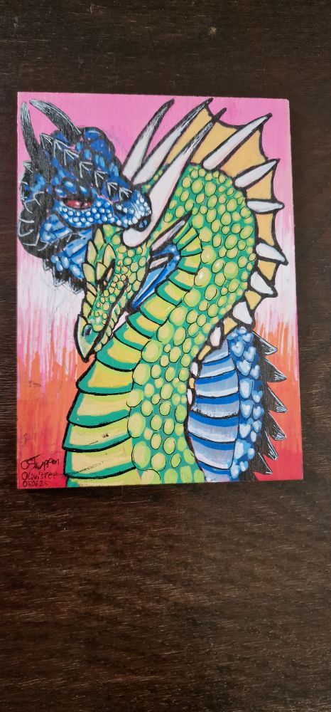 Lesbian flag with a blue and green dragon pair snuggling on it.