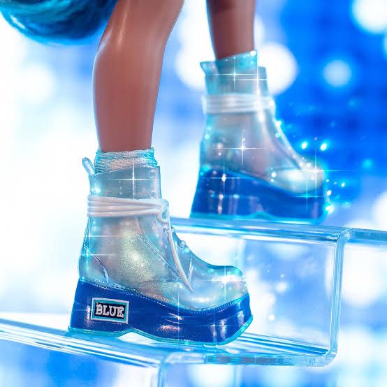 Blue clear plastic doll boots with white molded laces and a blue painted sole 