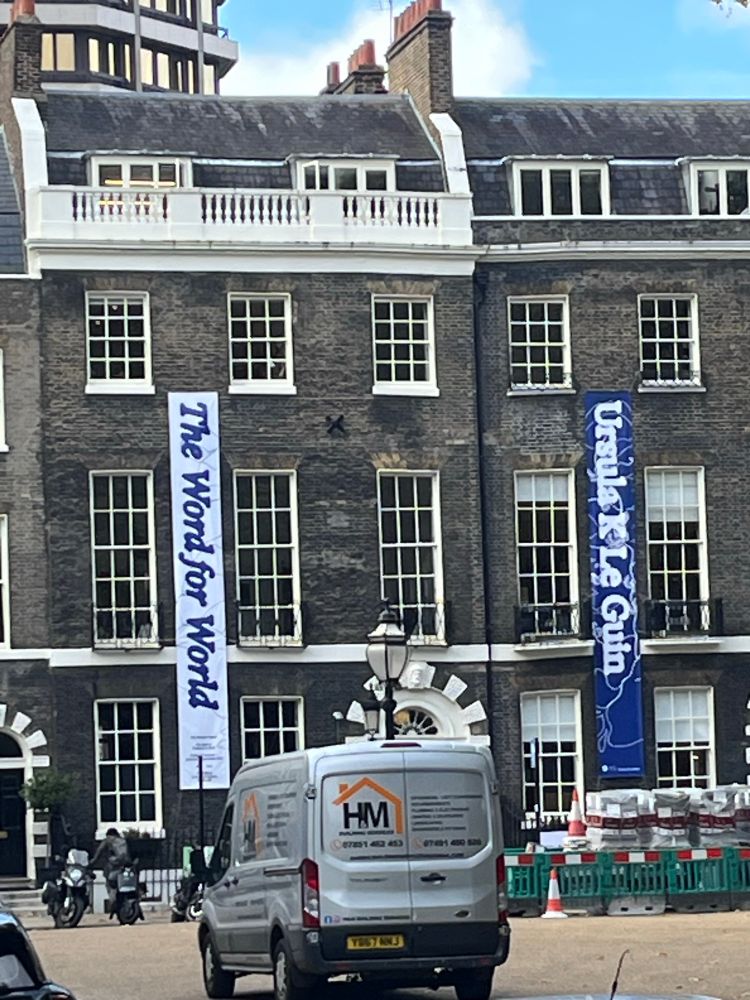 The exterior of the Architectural Association building, Bedford Square, London, showing big vertical banners advertising the Le Guin exhibition.