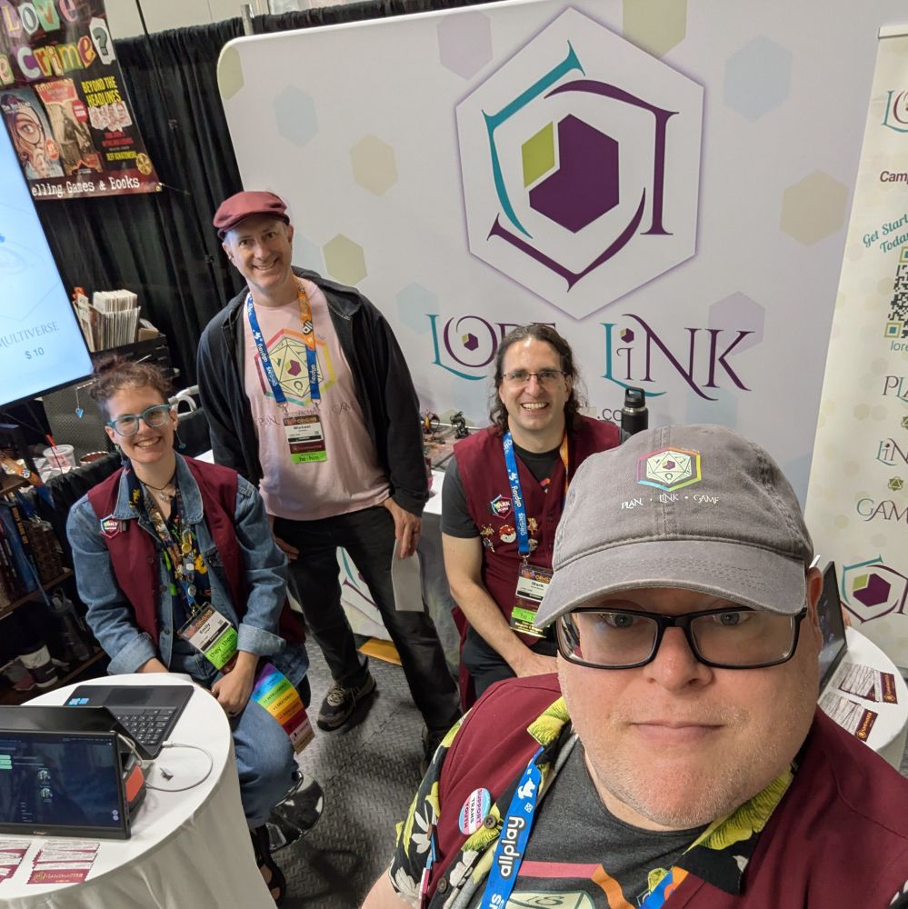 A selfie of the Lore Link booth workers in their booth.