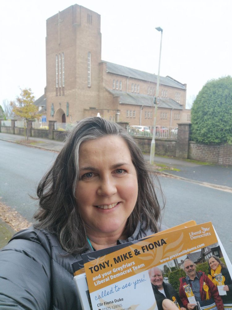 Cllr Fiona Duke on Marlborough Drive delivering community surveys. The church is behind her.