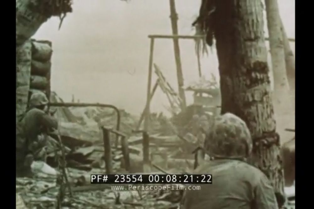 Screen capture from the documentary With the Marines at Tarawa showing US Marine riflemen firing on Japanese soldiers rushing out of a bunker. Too graphic for American film standards, this film was personally  approved for release by President Roosevelt. 