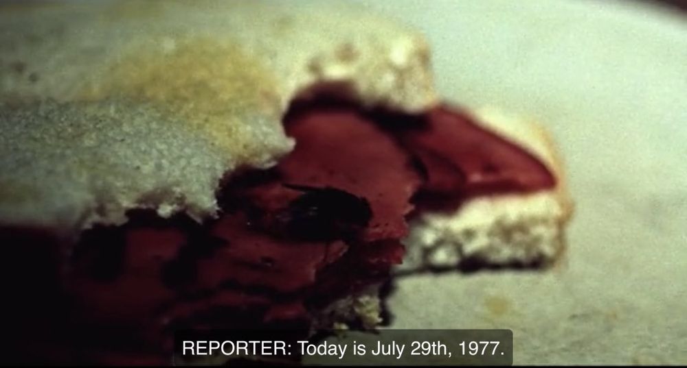 1 Screenshots from the movie "Summer of Sam" (1999): First, a close-up of a partially eaten sandwich with slices of red meat on white bread sits on a plate, with the subtitle "REPORTER: Today is July 29th, 1977."