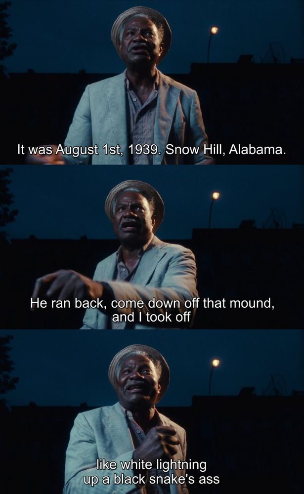 3 Screenshots from the movie "Do the Right Thing" (1989): First, a man in a light-colored jacket and hat stands outside at dusk, illuminated by streetlights, with the subtitle "It was August 1st, 1939. Snow Hill, Alabama." Second, the same man gestures with his hands while speaking, the subtitle reading "He ran back, come down off that mound, and I took off." Third, the man continues his animated storytelling, the subtitle stating "like white lightning up a black snake's ass."