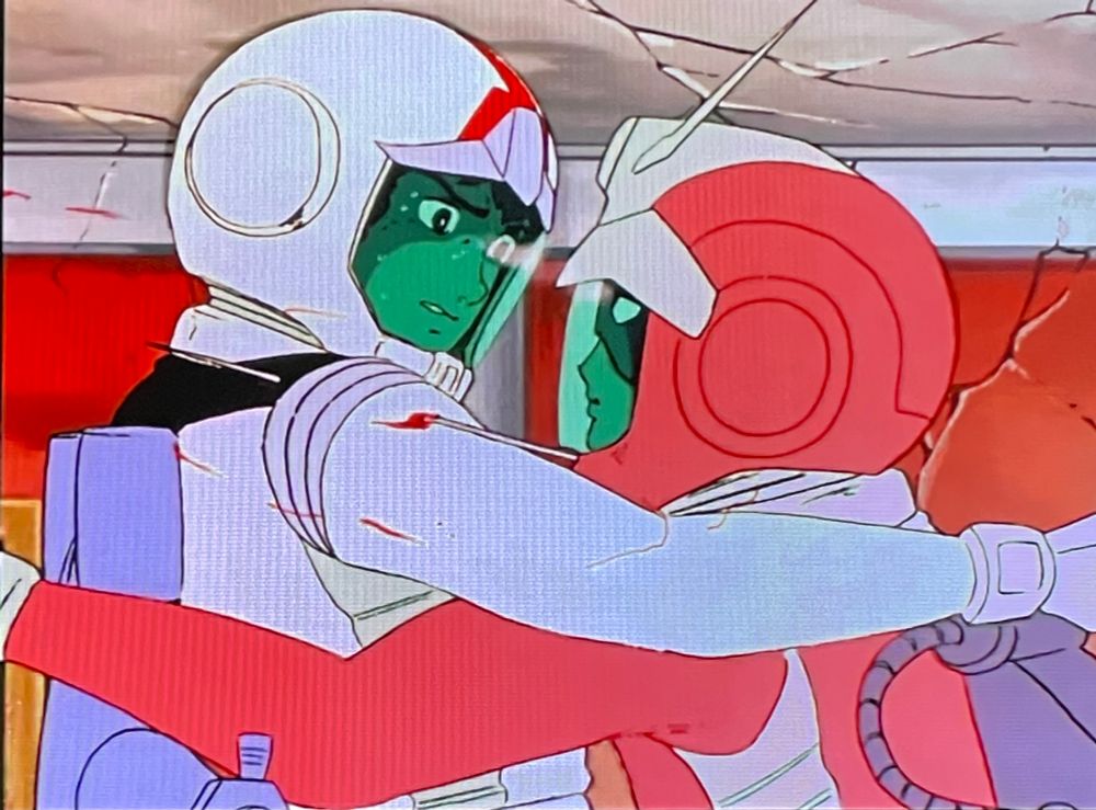 Amuro and Char from 1979’s Mobile Suit Gundam, locked in a zero gravity embrace, mid-duel.