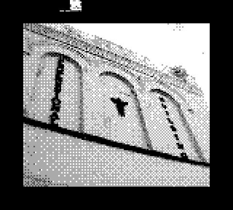 black and white low resolution photo, a brick building labeled "hospital" in vertical text with a little angel bust in center