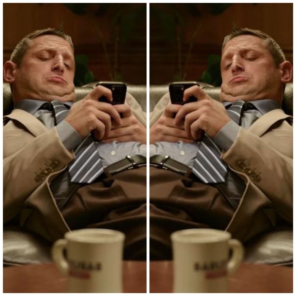 Two men typing on their phones