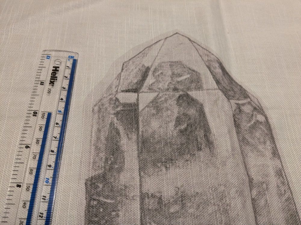 A close up of the top of the tea towel in the photos in the previous skeet. It shows the top 15cm of the quartz crystal drawing, showing three faces of the prismatic crystal.