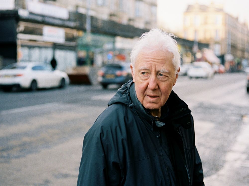 A man pauses on the street in Glasgow