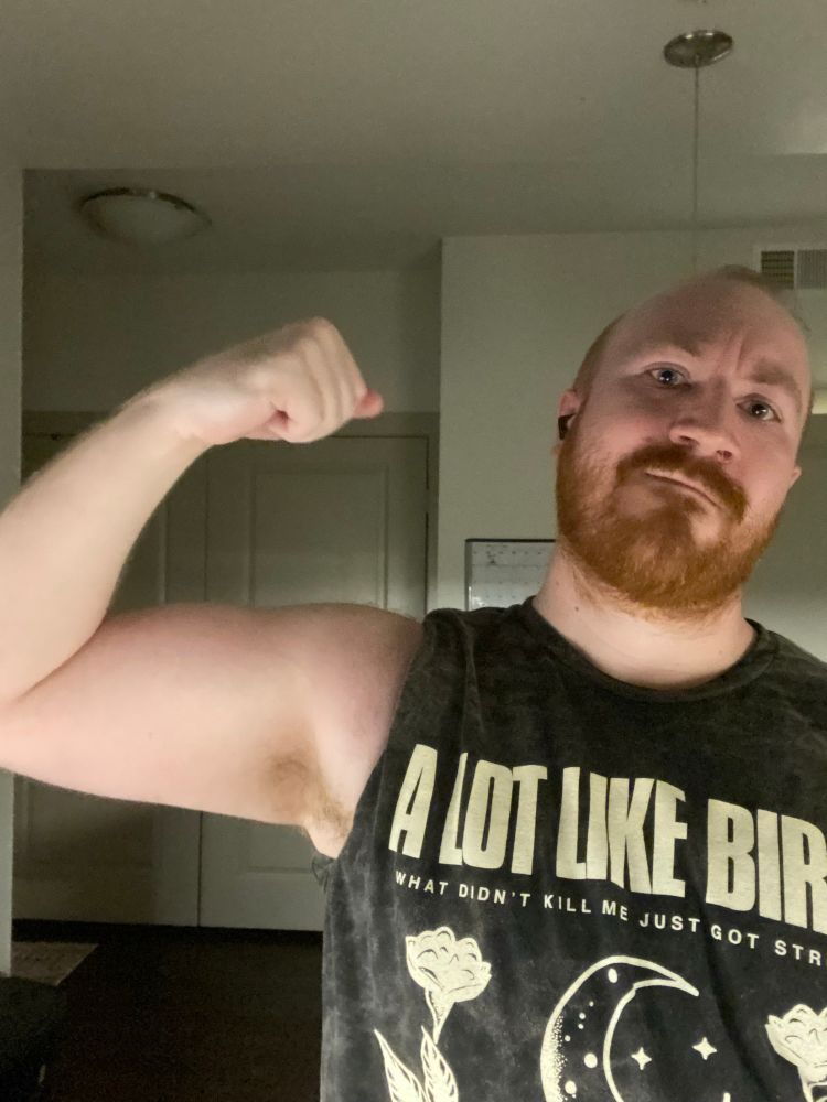 Bear sweaty and pumped from a late workout showing off bicep and pit, as a treat