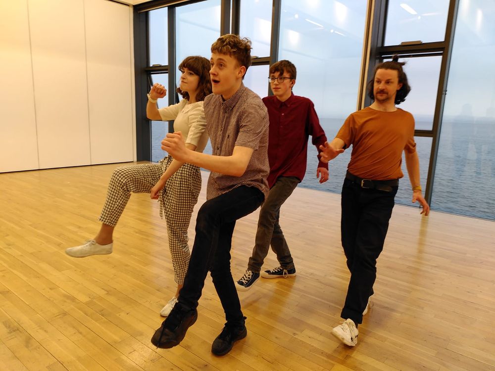 Performers rehearsing in a studio