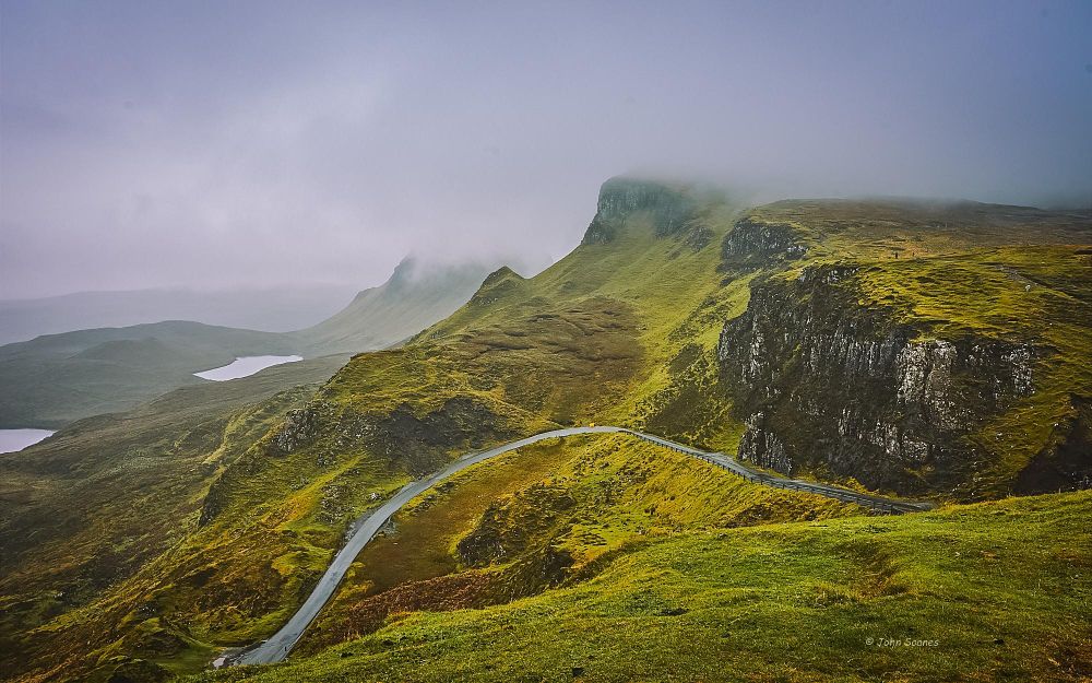 The Quiraing, stunning when wet!  It's a pause, between sideways rain, epic really.  There's mist over the lochs and peaks that brings a silent calm, there's absolutely nobody here with us.  The road winds down through the hills of punched-up greens thanks to the constant moisture.  The air is thick and rejuvenating.   Time to go hide in the car:-) 