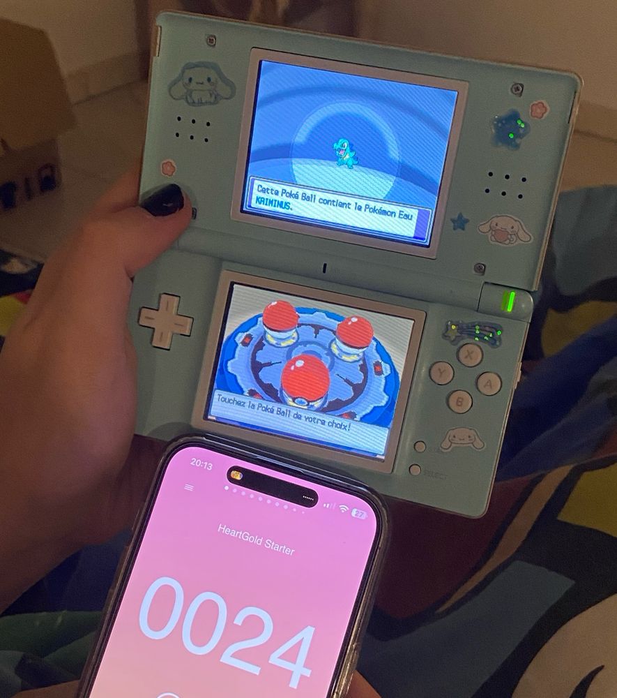 image showing a nintendo ds lite and an iphone.
The Nintendo DS displays gameplay of Pokemon HeartGold. There's a shiny Totodile on the screen. The iPhone displays the interface for a counter app, the counter is at 24.