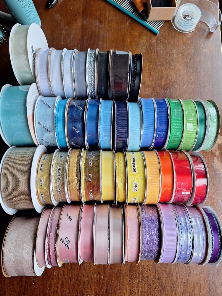 spools of ribbon in rainbow colors 
