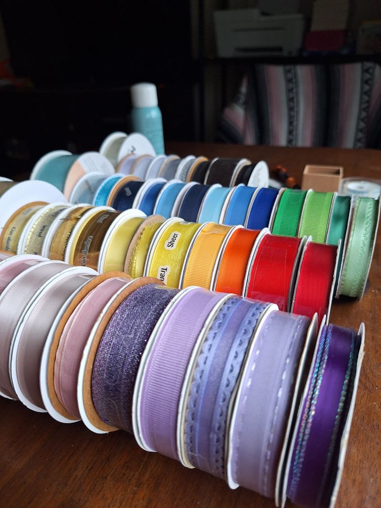 spools of ribbon in rainbow colors 
