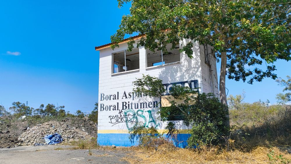 masonry block building with advertising on it. Old calling tower.