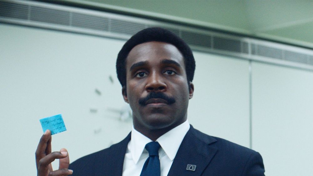 Milchick (de Ruptura), sério, segurando um pedaço de papel 