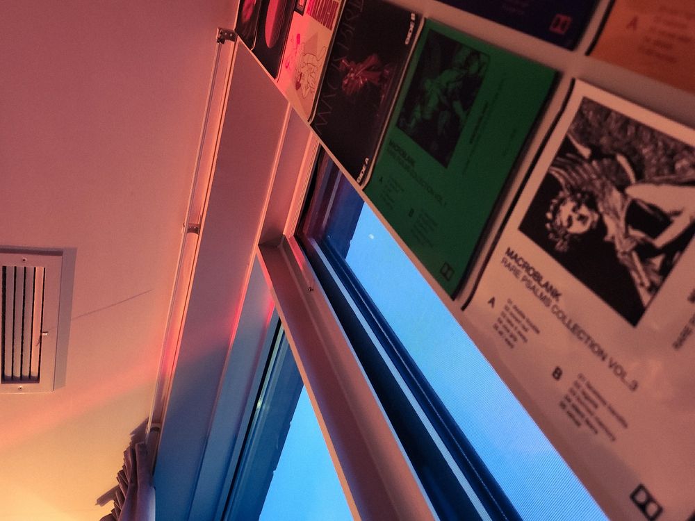 the half moon at twilight, barely visible through the top corner of my window 