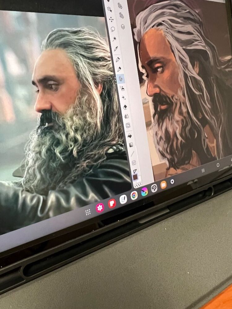 a photograph of a samsung galaxy tablet 9 screen with two windows open: on the left is a still of Ed Teach from Our Flag Means Death in episode 9 when he pulls off Stede's blindfold. On the right is an artistic rendition of Ed in profile, obviously referenced from the image, though the lighting appears warmer and he's not wearing his leather jacket.
