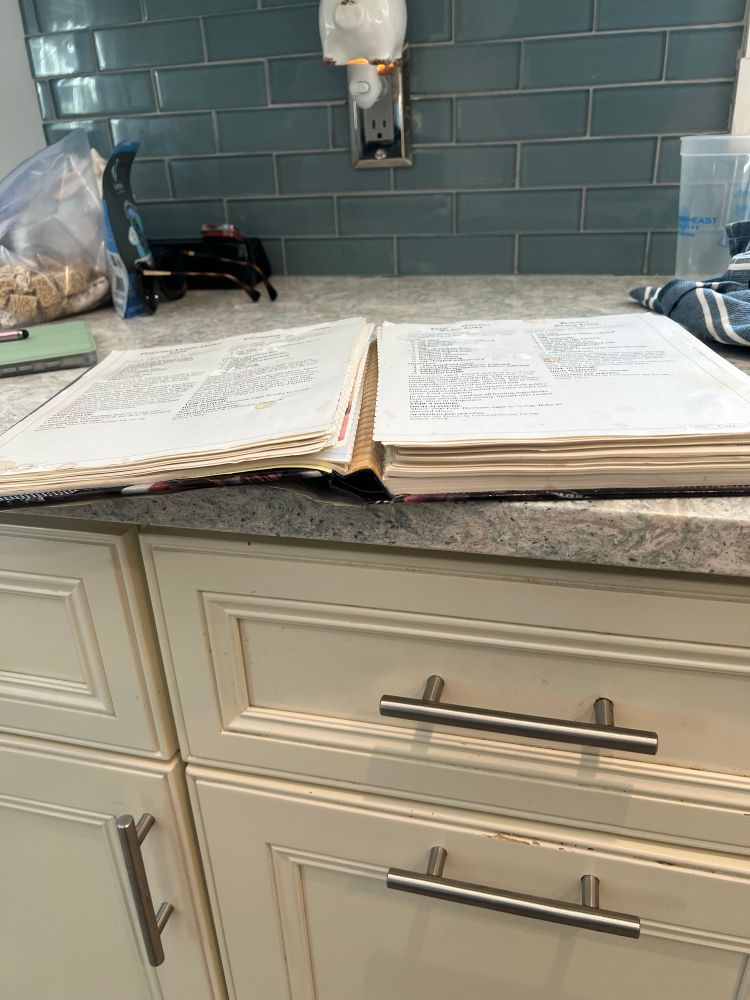 A pillsbury bakery cookbook from 1990(?), falling apart at the binding, pages no longer connected to the book or each other