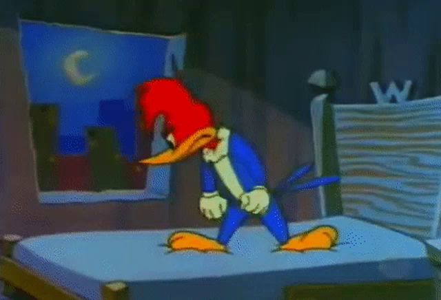 woody woodpecker is standing on a bed in a room