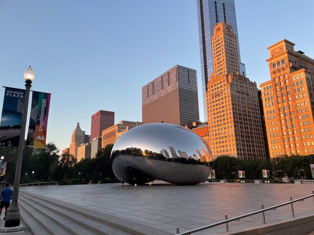 Morning photo of The Bean sculpture in Chicago’s Millennium Park, with Michigan Ave buildings in the background