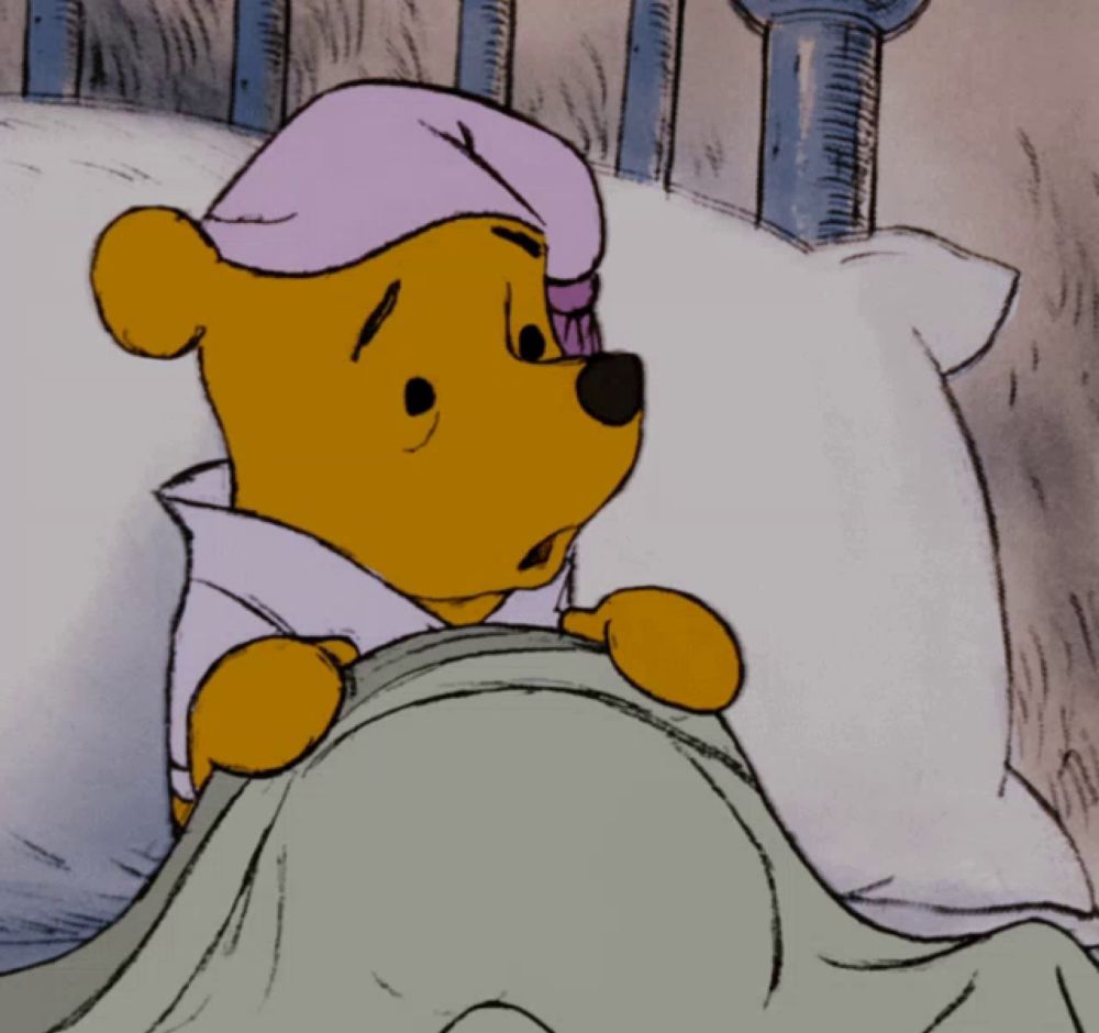 a cartoon of winnie the pooh wearing a purple hat